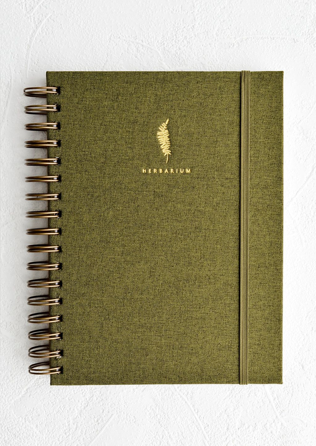 Green: A cloth covered spiral bound journal with gold foil fern and "Herbarium" in small text.