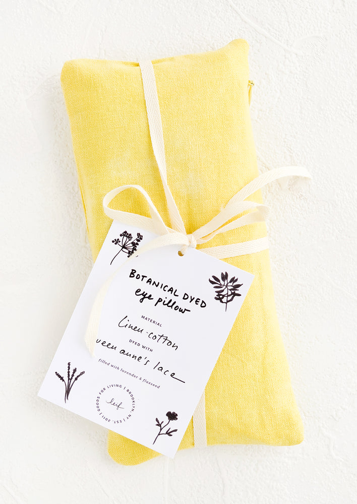 A naturally dyed relaxation eye pillow in yellow color dyed using Queen Anne's Lace.