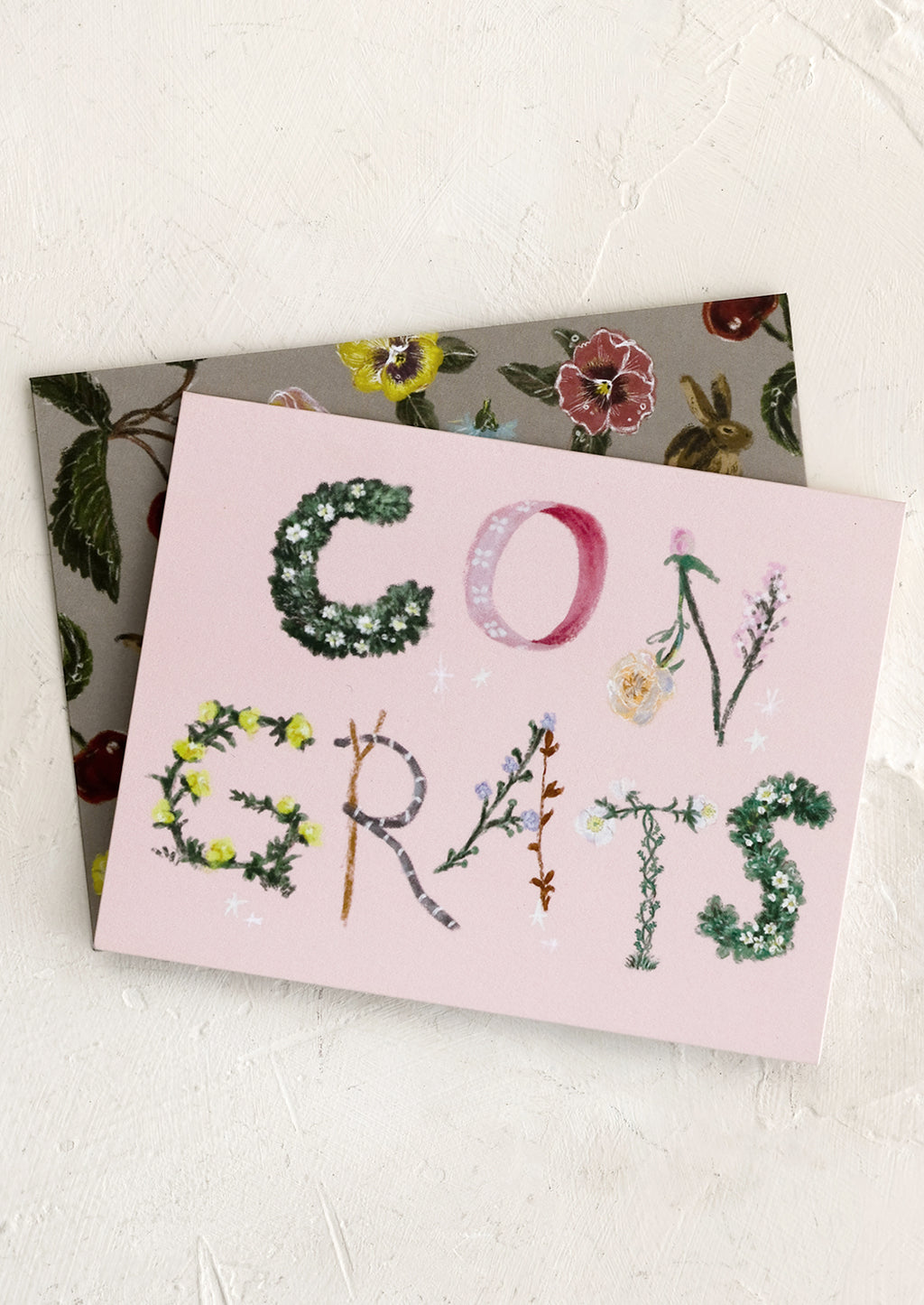 1: A pink congratulations card with botanical lettering.