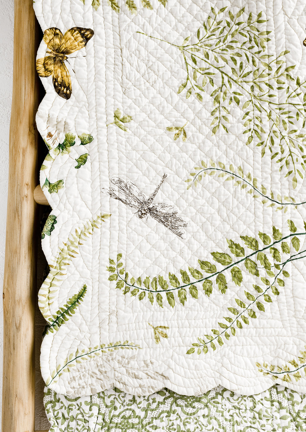 2: A quilted table runner with fern print.