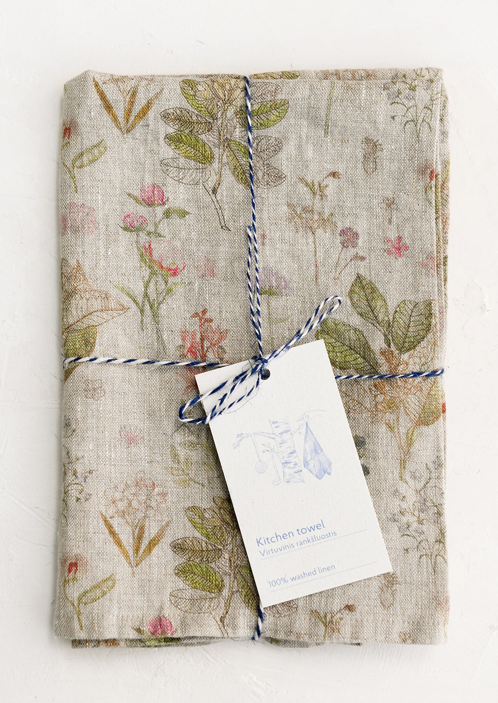 Natural Multi: A botanically printed natural linen tea towel, folded and tagged.
