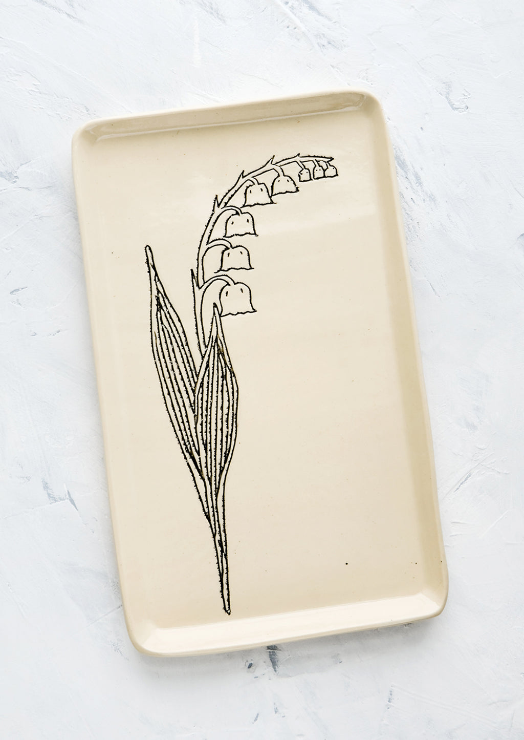 Lily of the Valley: A rectangular ceramic tray in natural bisque color with an etched black drawing of Lily Of the Valley flower.