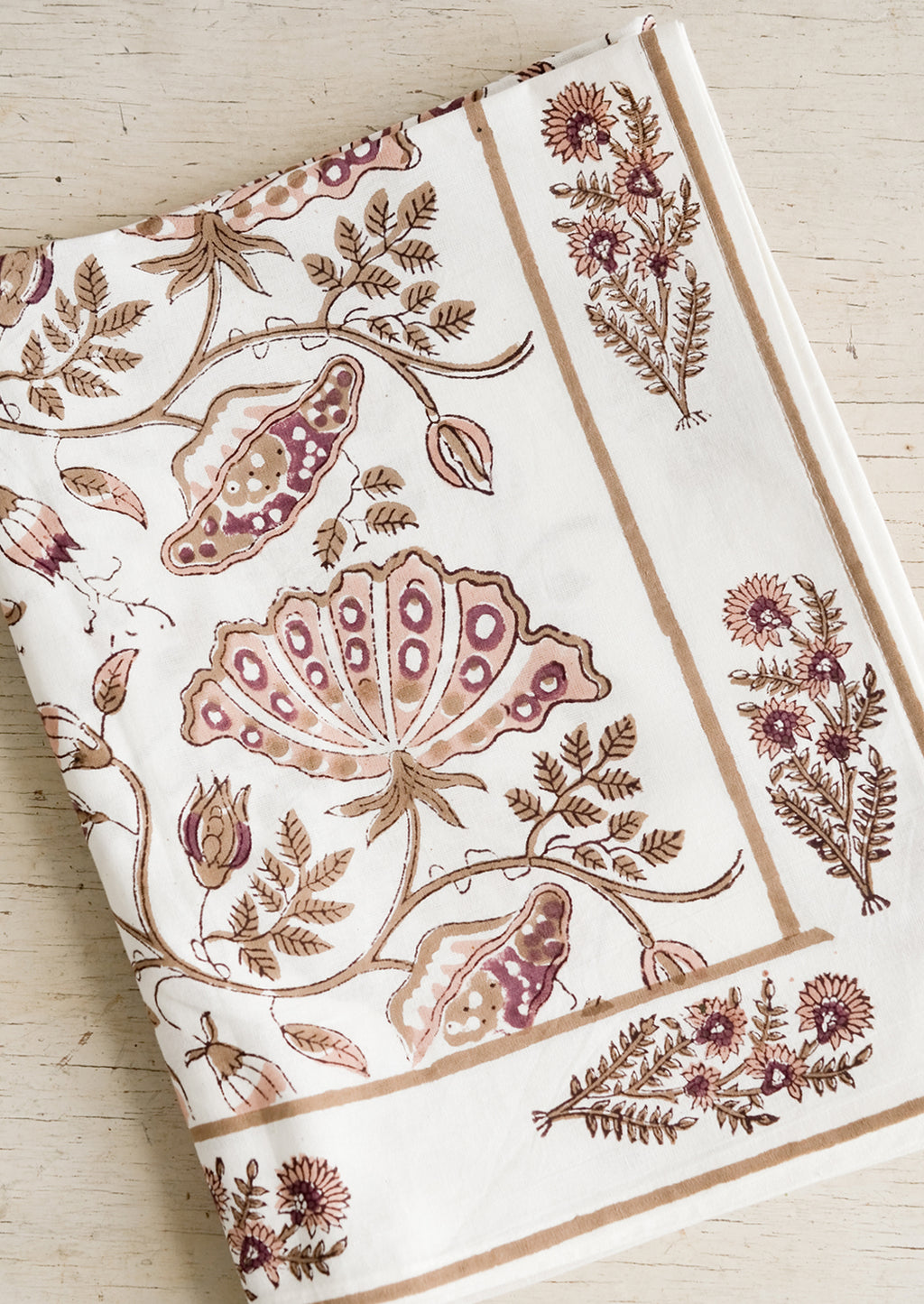 Rose Multi: A botanical block printed tablecloth in brown, pink and wine.
