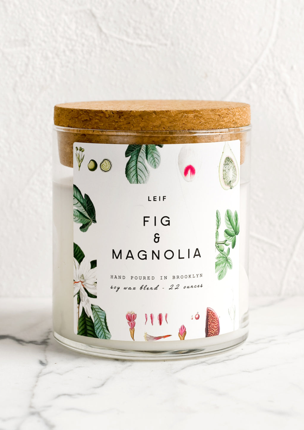 Fig & Magnolia: A glass jar candle in Fig & Magnolia scent with botanical print label.