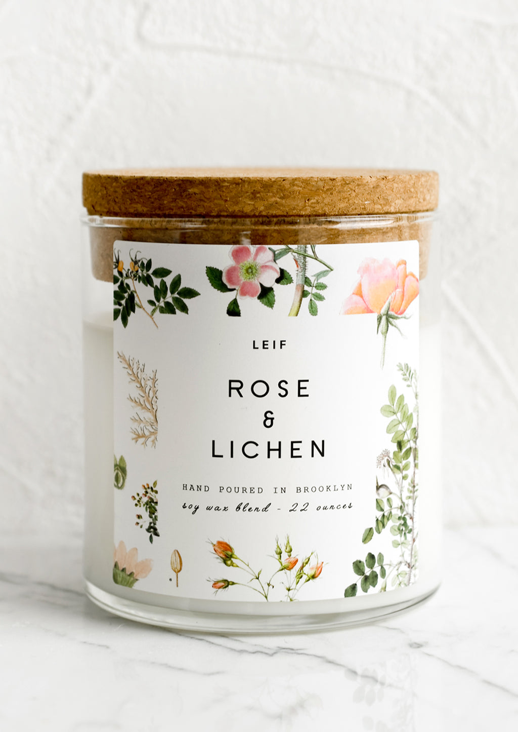 Rose & Lichen: A glass jar candle in Rose & Lichen scent with botanical print label.