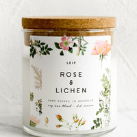 Rose & Lichen: A glass jar candle in Rose & Lichen scent with botanical print label.