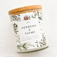 Verbena & Thyme: A glass jar candle in Verbena & Thyme scent with botanical print label.
