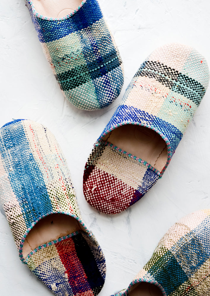 4: An assortment of house slippers made from colorful plaid fabric.