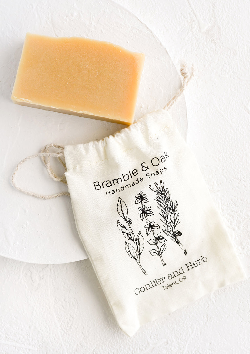 Conifer & Herb: A printed muslin bag with a bar of soap.