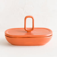 Papaya / Oval: An oval shaped lidded ceramic container in papaya orange.