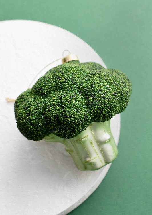 A decorative holiday ornament in shape of head of broccoli.