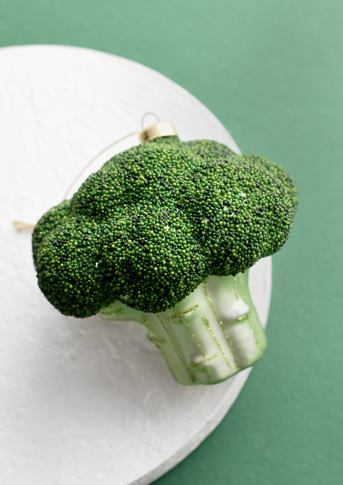 A decorative holiday ornament in shape of head of broccoli.