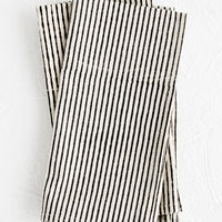 Black Stripe: A stack of folded fabric napkins in natural cotton with hand-drawn line pattern in black.