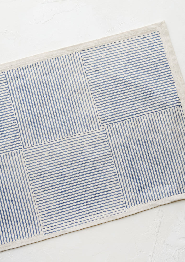 Natural / Indigo: Block printed cotton placemat with boxed stripe pattern in dusty blue.