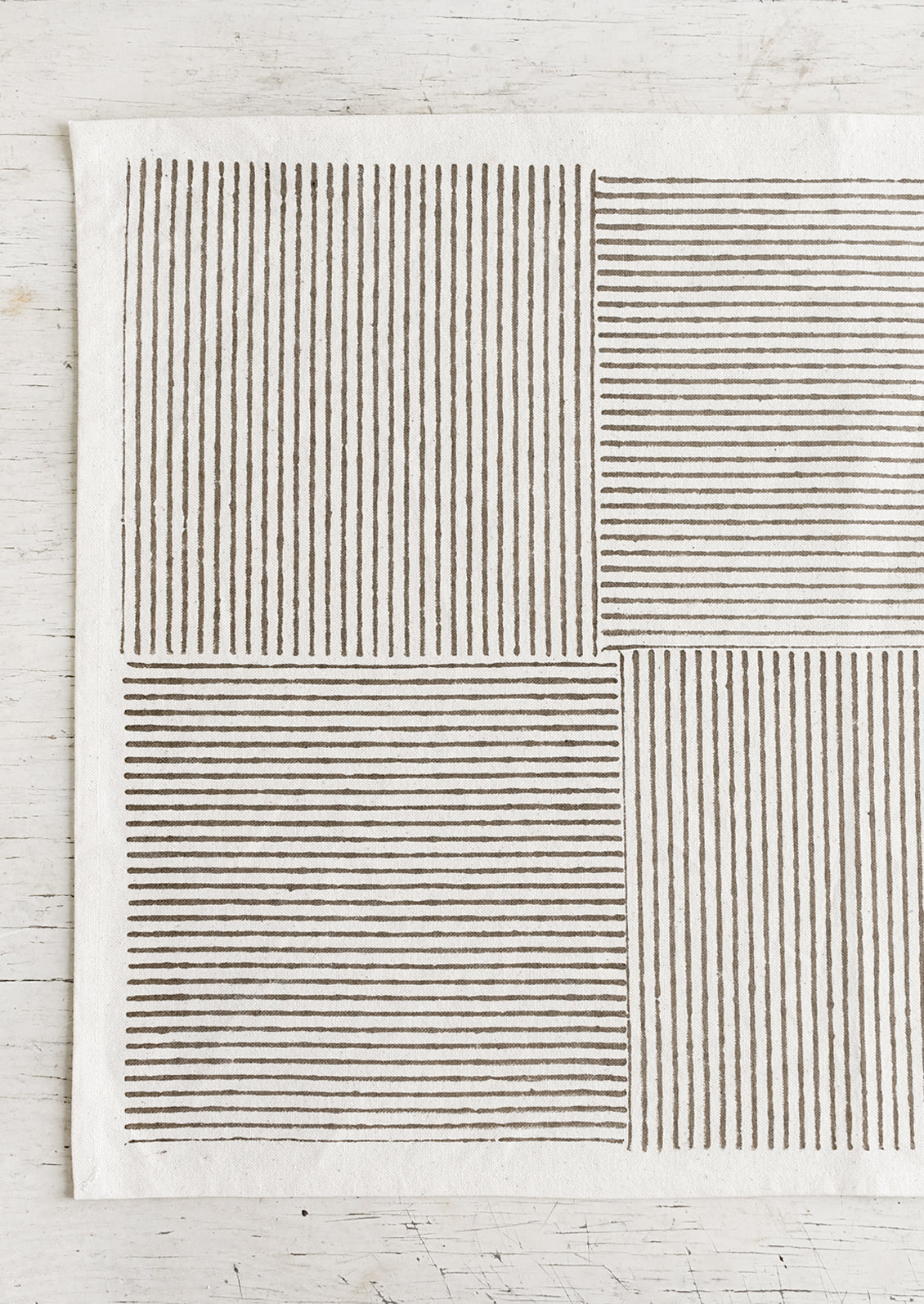 Block printed cotton placemats with boxed stripe pattern in khaki.