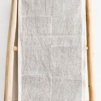 1: A natural cotton table runner with black broken stripe block print.
