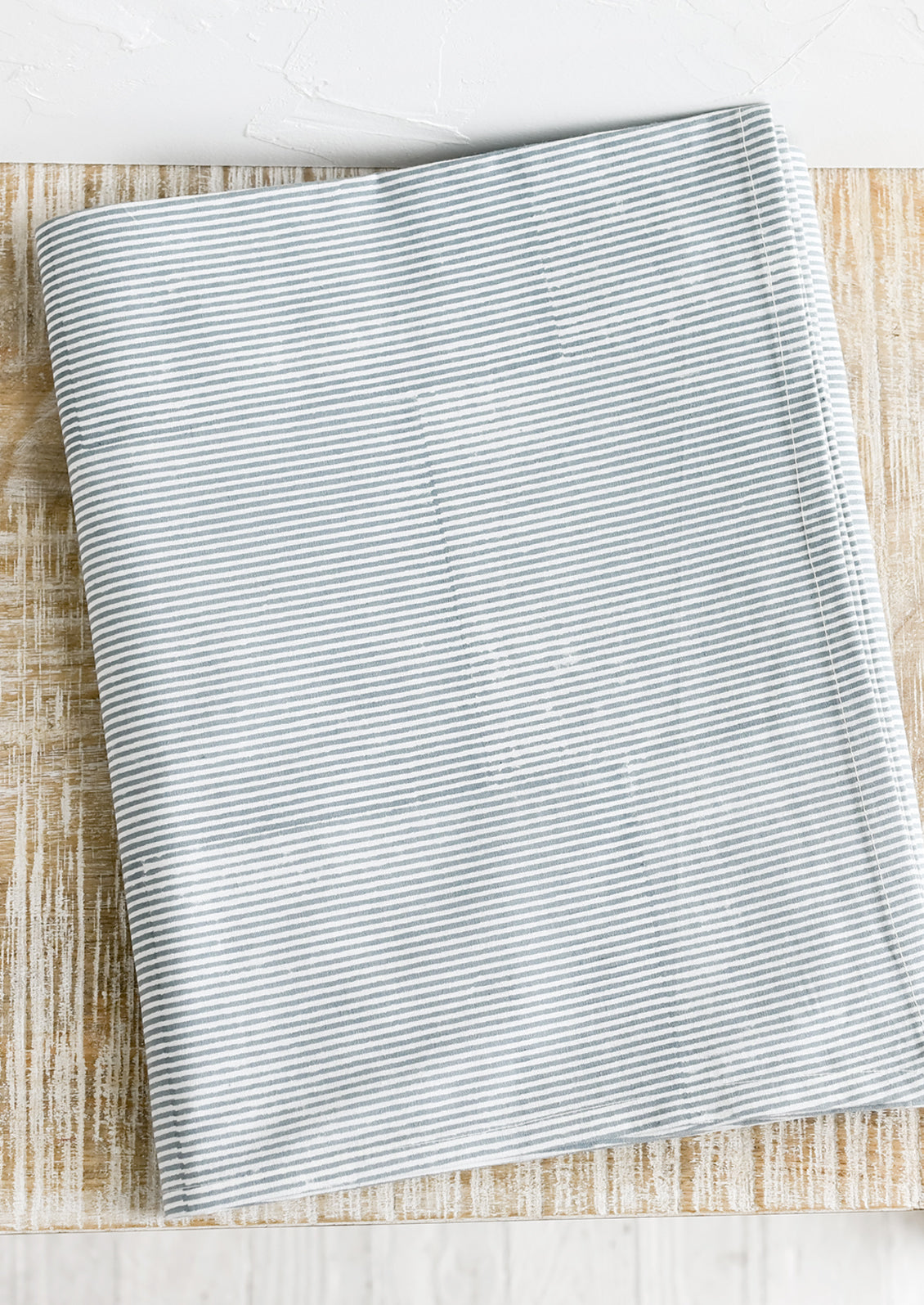 A stripe pattern tablecloth in dusty blue.