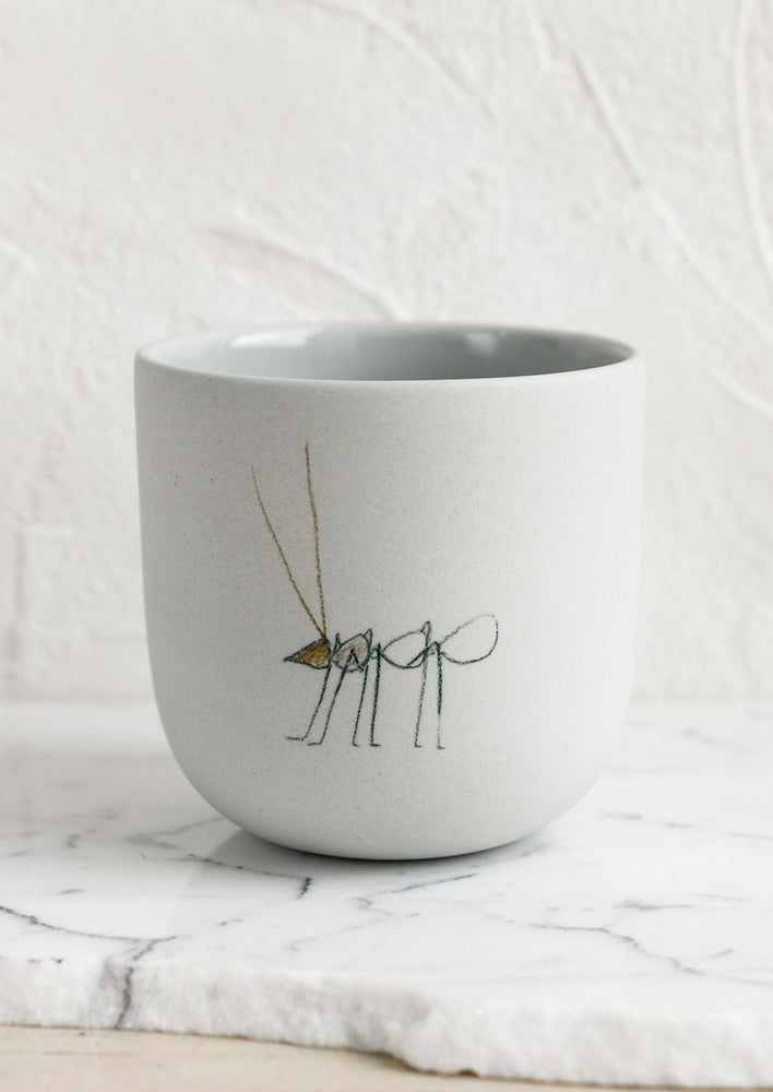 A large pastel grey porcelain cup with ant sketch.