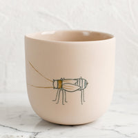Large / Beetle / Nude: A large pastel orange porcelain cup with beetle sketch.