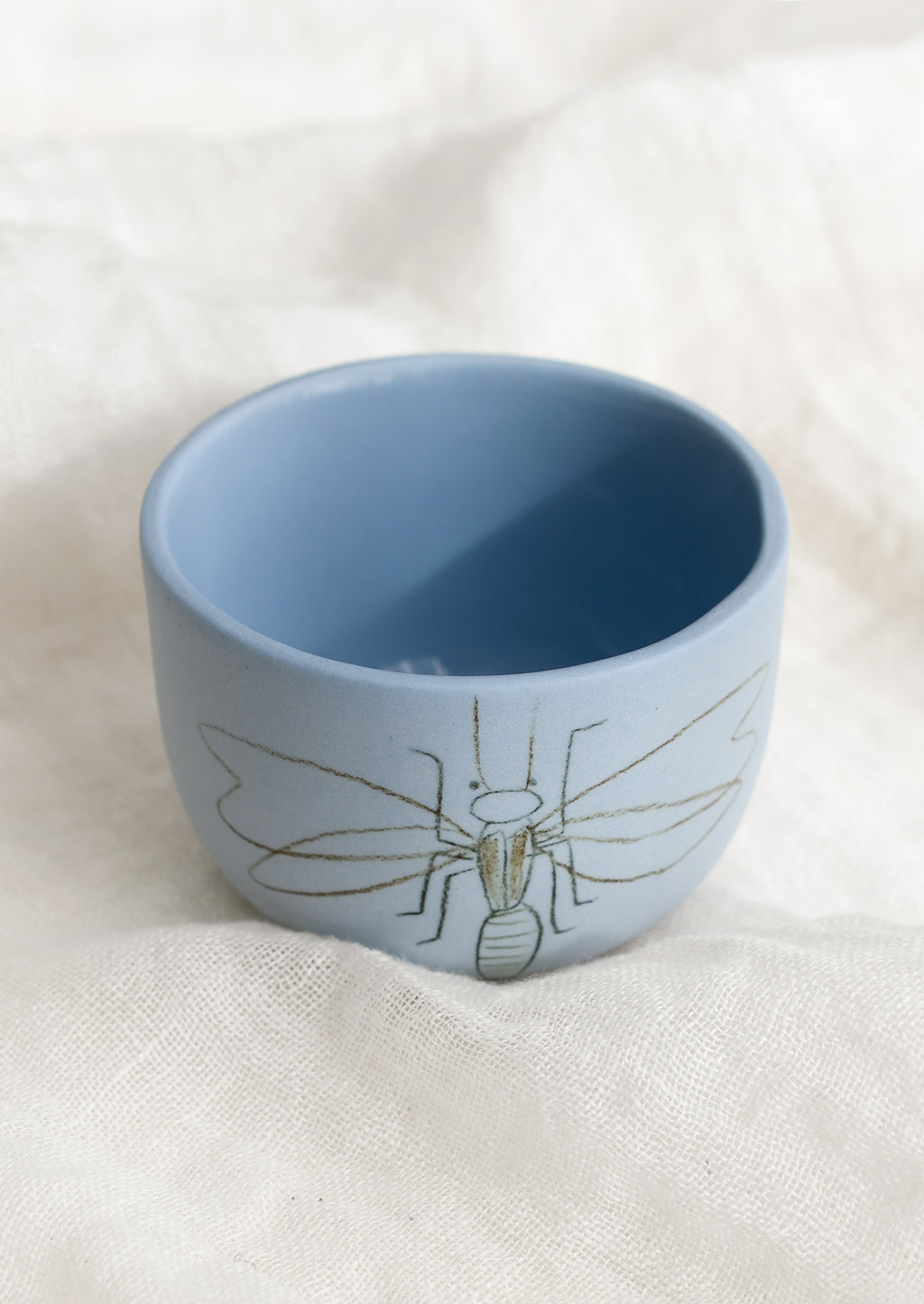 Small / Firefly / Periwinkle: A short and wide periwinkle blue cup with firefly sketch.