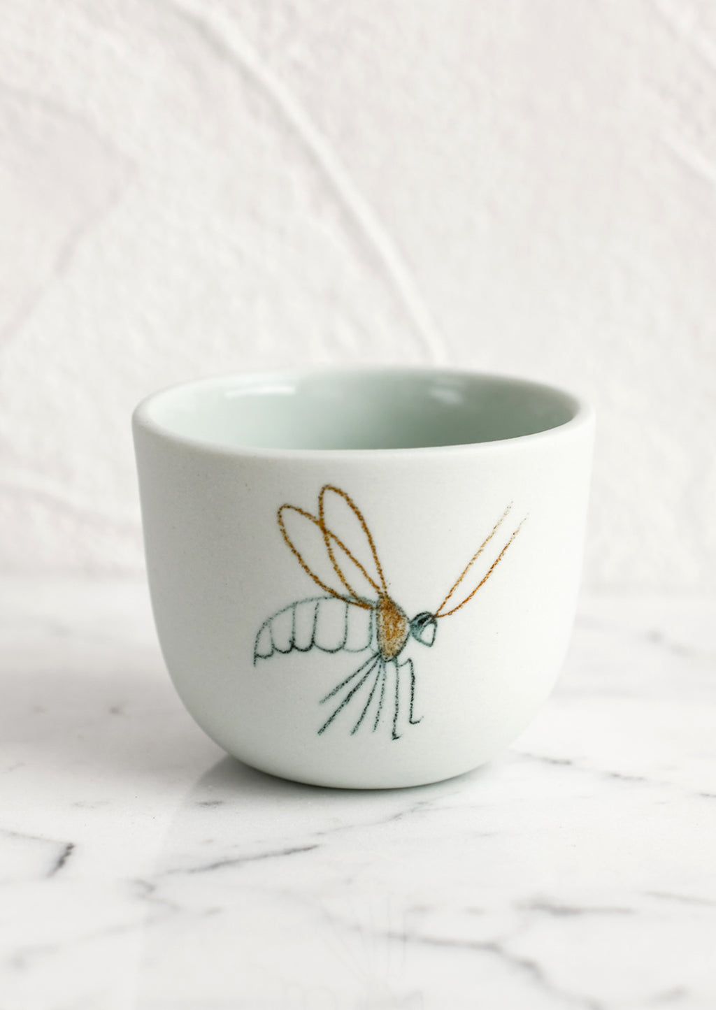 Extra Small / Crane Fly / Mint: An extra small mint porcelain cup with cranefly sketch.