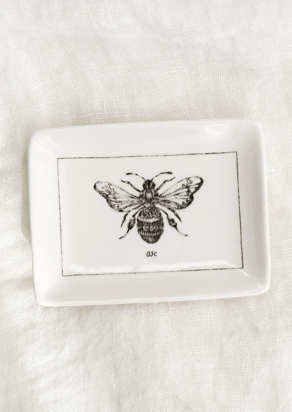Bee: A black and white trinket dish with bee.
