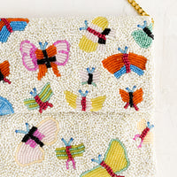 2: A butterfly beaded clutch with gold chain shoulder strap.