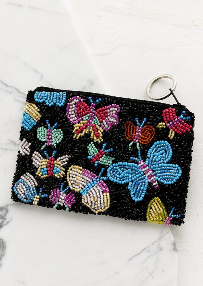 1: A black beaded coin pouch with colorful butterfly design.