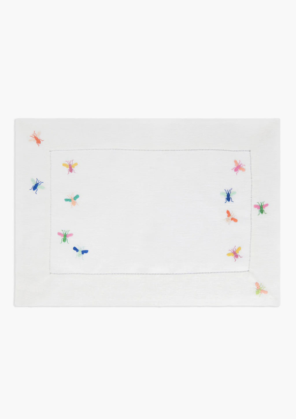2: A white linen placemat with multicolor bee embroidery.