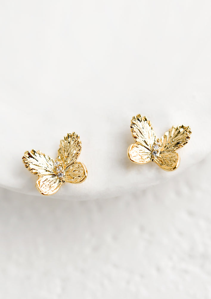 Butterfly shaped stud earrings in gold.