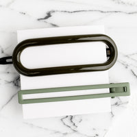 Forest Multi: A pair of hair clips in oval and rectangular shapes in shades of forest green.