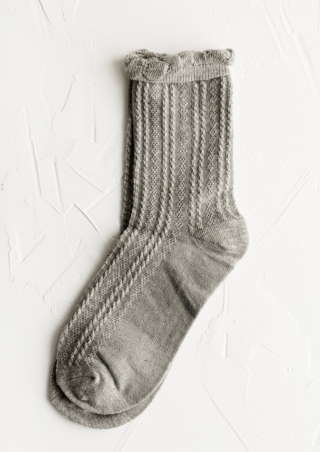 Heather Grey: A pair of cable knit socks with ruffled ankle in heather grey.