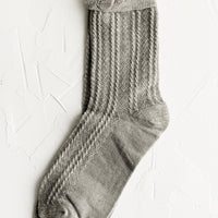 Heather Grey: A pair of cable knit socks with ruffled ankle in heather grey.