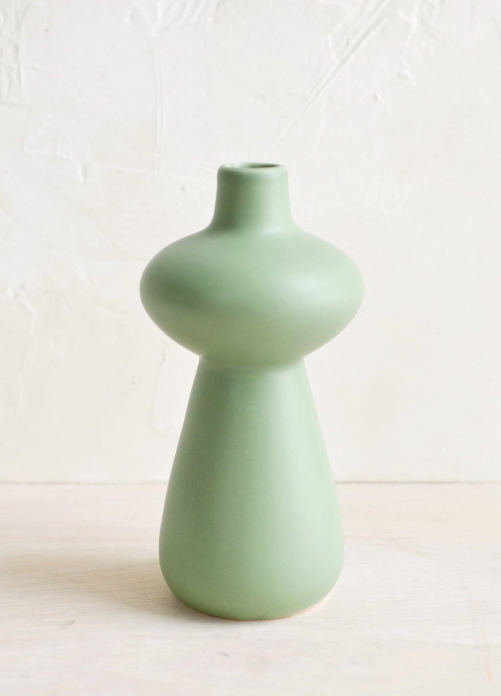 Hourglass: A mint green ceramic bud vase in curvy hourglass silhouette.