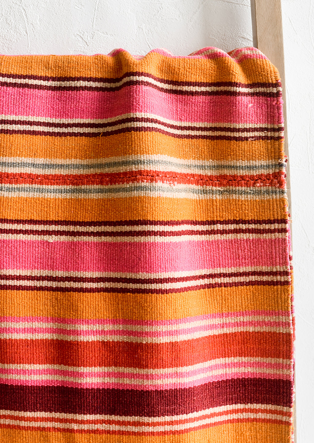 2: A vintage textile in thin pink, orange and burgundy stripe.