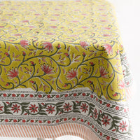 2: A block printed tablecloth in yellow, pink and green floral.