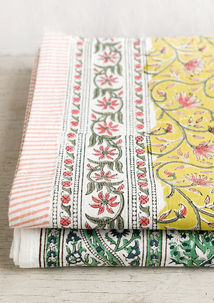 3: A block printed tablecloth in yellow, pink and green floral.