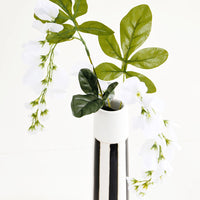 3: Tall and skinny black and white striped ceramic vase with flowers