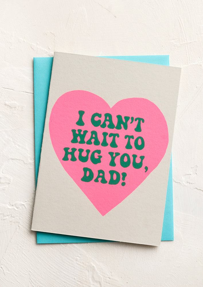 1: A greeting card with text inside pink heart reading "Can't wait to hug you dad"