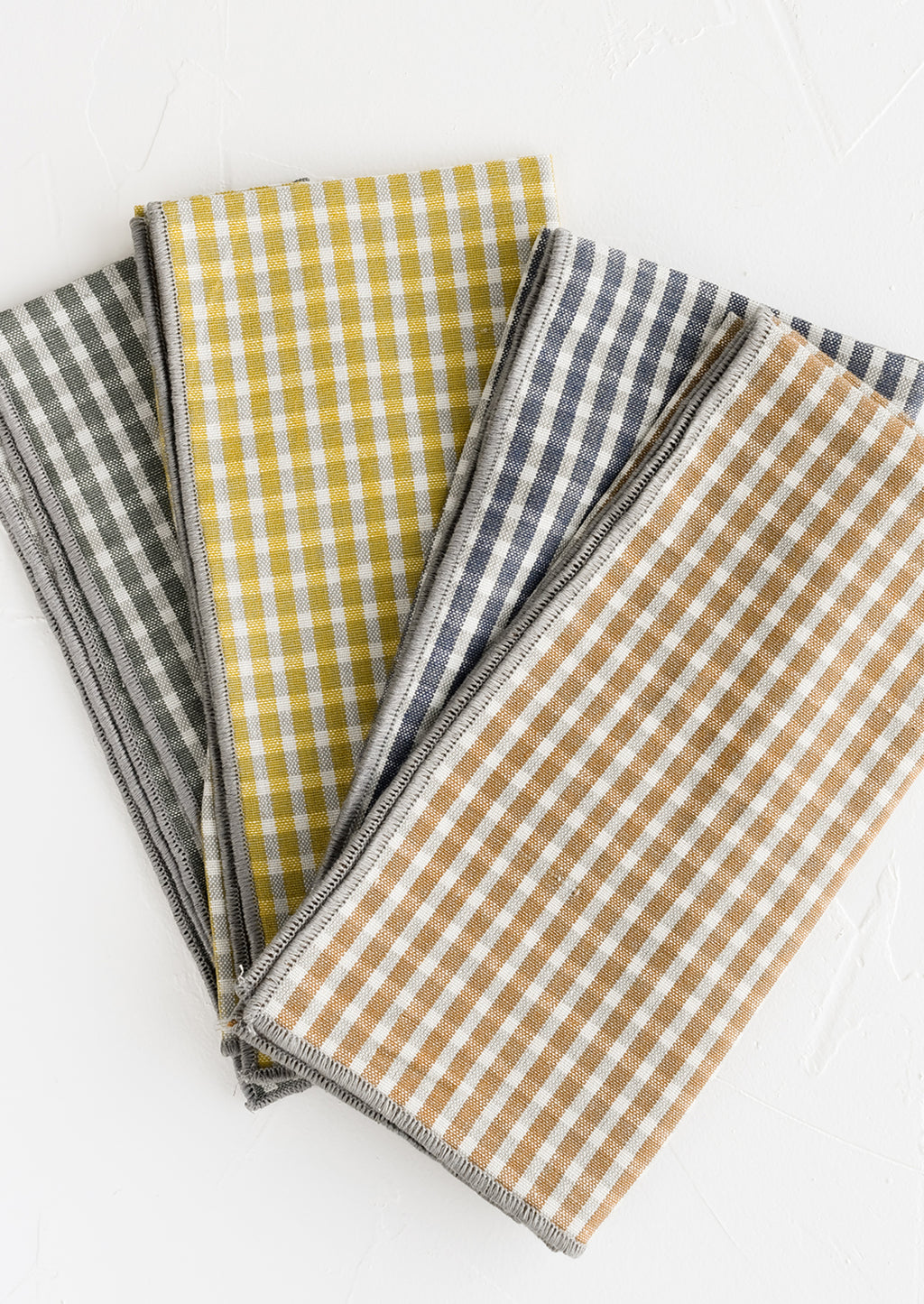 3: A set of four plaid print napkins in a mix of colors.