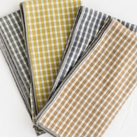3: A set of four plaid print napkins in a mix of colors.