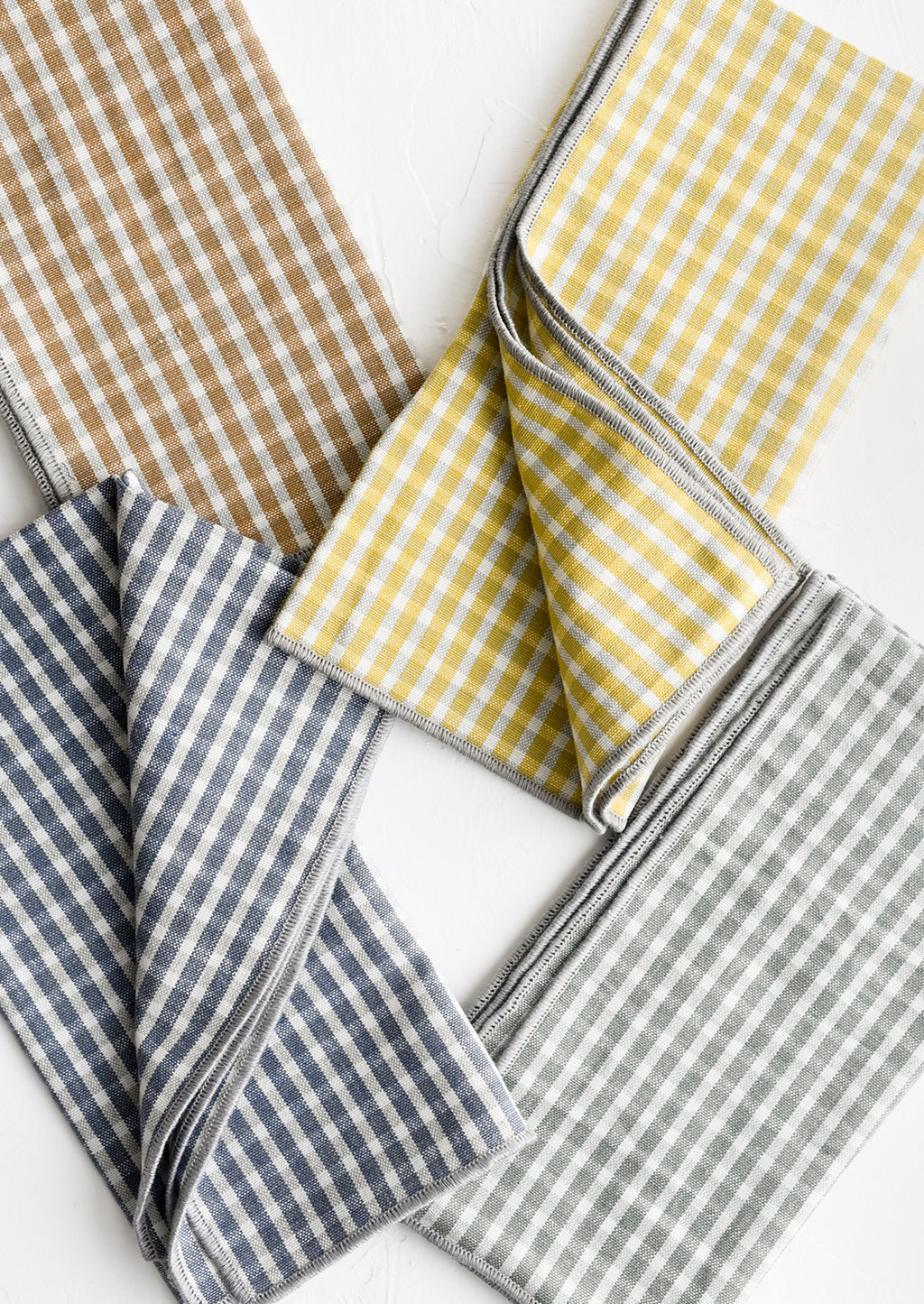 1: A set of four plaid print napkins in a mix of colors.
