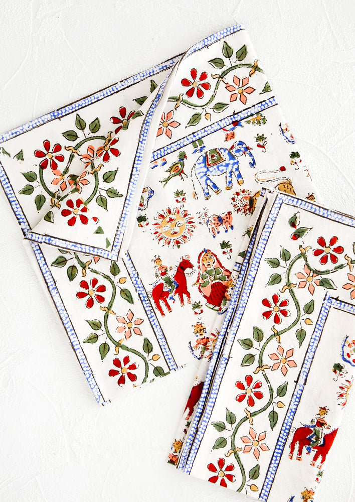 Pair of cotton dinner napkins in white with multicolor carnival print