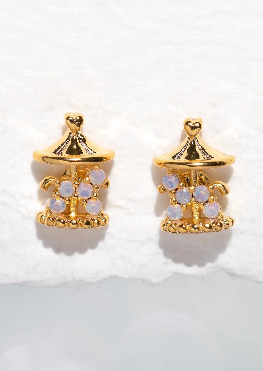 2: A pair of gold stud earrings in shape of carousel.