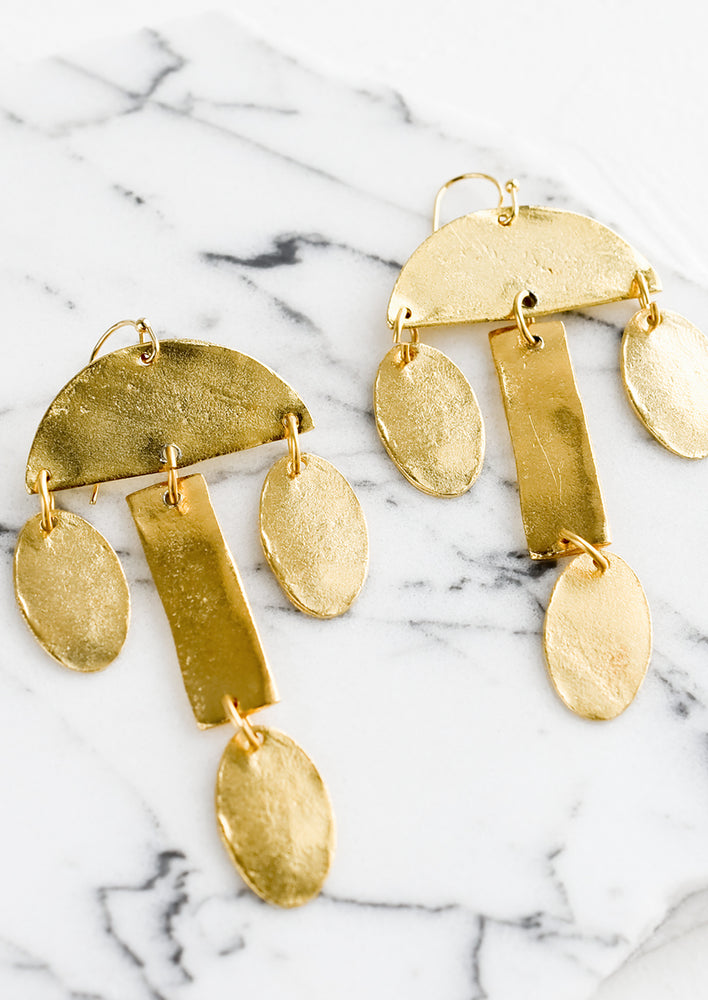 1: A pair of gold drop earrings in tiered chandelier shape.