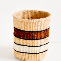 1: Small, round storage basket in striped pattern of peach, brown and white