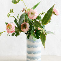 1: A blue and white vase with ranunculus arrangement.