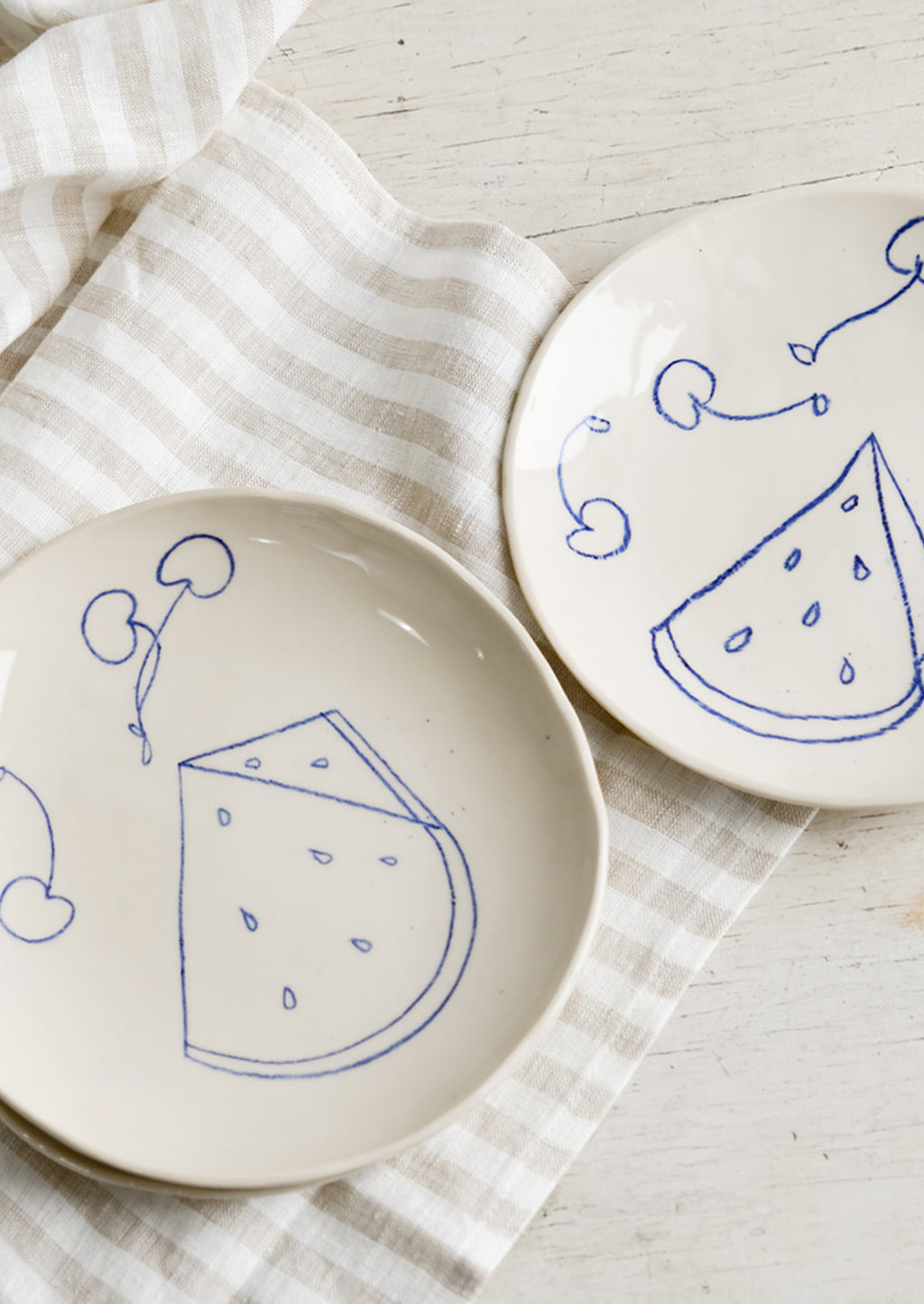 Side Plate: Two ceramic side plates with still life fruit drawings in blue.