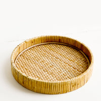 1: Round serving tray with raised rim, made from woven rattan