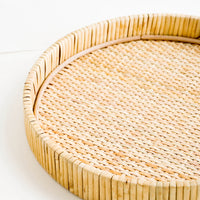2: Round serving tray with raised rim, made from woven rattan